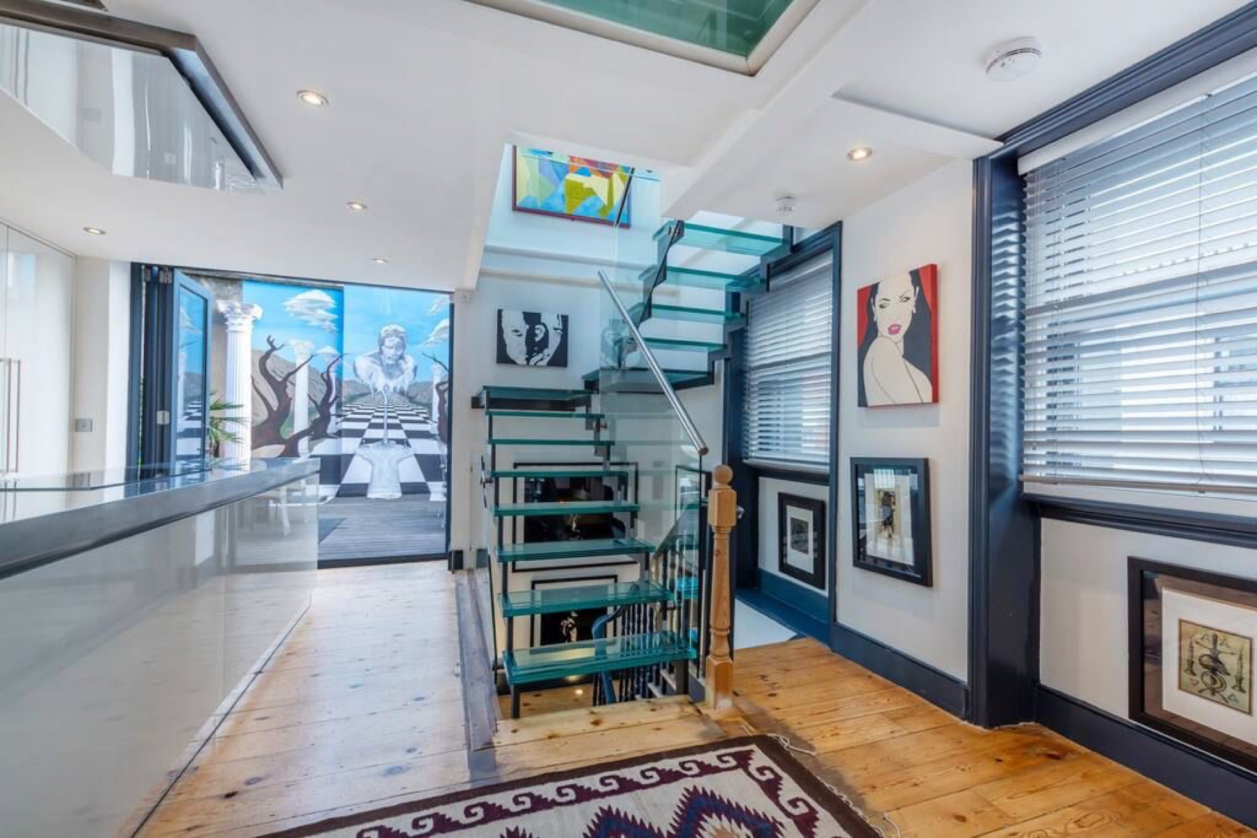 Glass staircase and artwork inside the Soho property